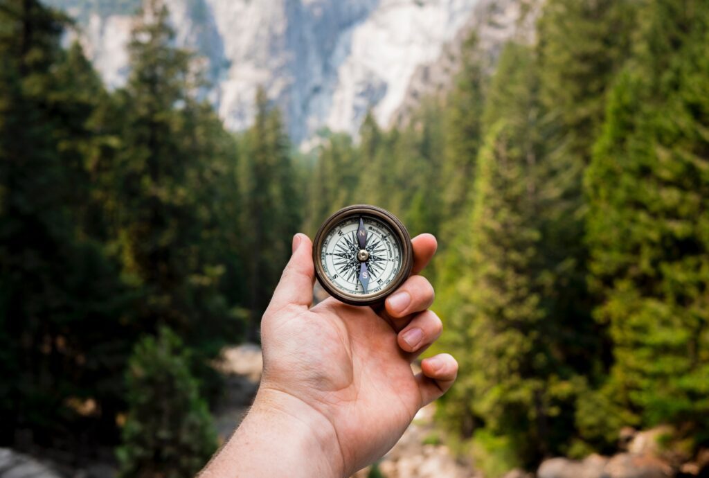 A man holding a compass to find his purpose driven life